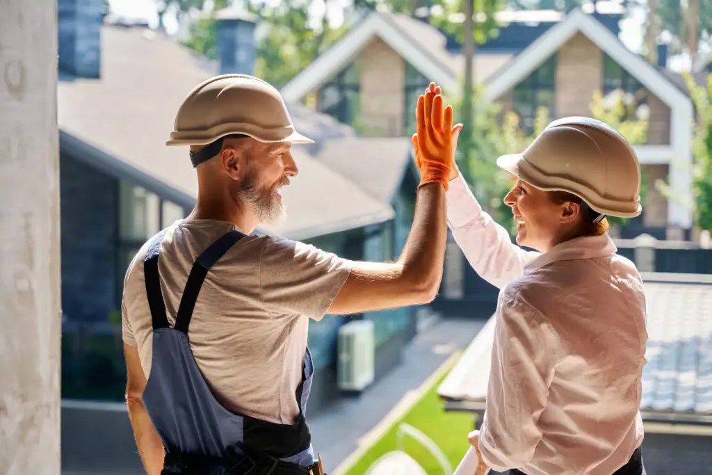 roofing contractors high fiving on a completed project